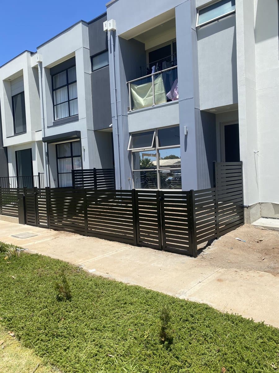 Black aluminium slat fencing on multi-storey residential development installed by ADs Maintenance Adelaide
