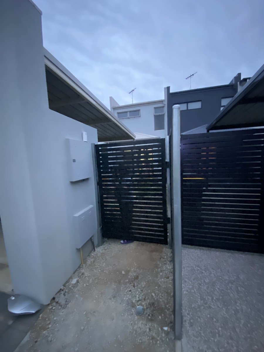 Modern black aluminium slat fence and gate installation by ADs Maintenance Adelaide